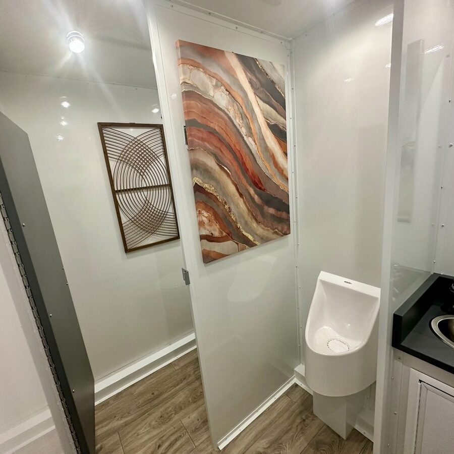 Clean restroom trailer vanity with plants — White Glove Restroom